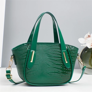 Deep green crocodile embossed tote bag with gold metal hardware and long shoulder strap