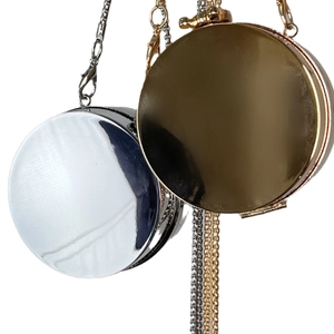 Mini acrylic round evening clutch bag in gold and silver mirror finish with chain straps