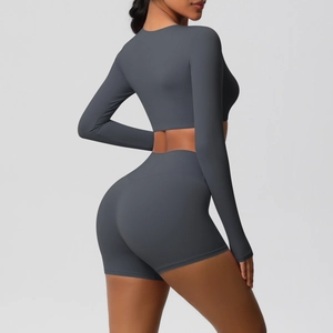 Rear view of tight yoga set showing grey long sleeve crop top and high waist shorts