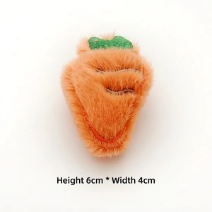 Detail of plush carrot accessory with soft texture and green leaves measuring 6cm by 4cm