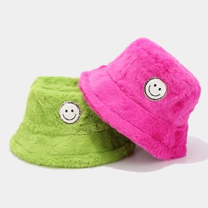 Winter plush bucket hat set in fluorescent green and bright pink with smiley patch