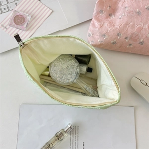 Detailed interior of a floral jacquard makeup bag showing its large storage capacity