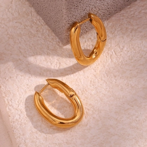 Detail view of gold-plated hoop earrings with a polished finish and smooth round shape