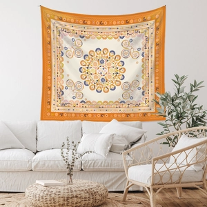 Detail view of a bohemian mandala tapestry hanging on a white wall in a modern living room