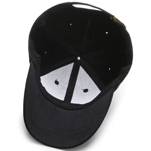 Internal view of black cotton baseball cap showing white reinforced lining and gold buckle