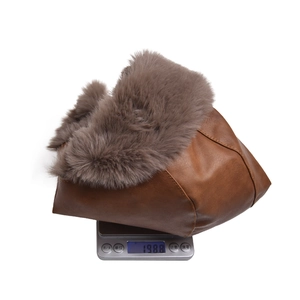 Winter faux leather trapper hat weighing approximately 198.8g on an electronic scale