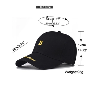 Detail of yellow 'B' embroidery on black washed cotton baseball cap with size specs