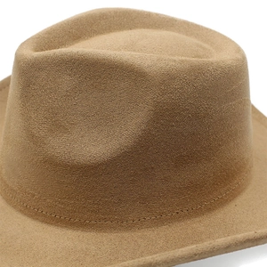 Close-up of camel felt fedora hat featuring fine stitching on wide brim and soft texture
