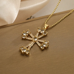 Gold-plated 18K cross pendant necklace with sparkling cubic zirconia on a luxury box