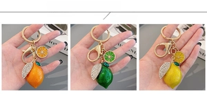 Detailed display of lemon and orange keychains with rhinestone leaves in three colors