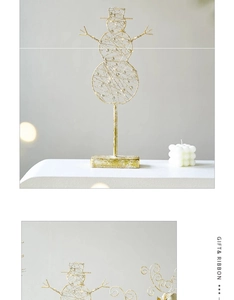 Detail of golden iron snowman ornament with integrated LED lights and sturdy square base