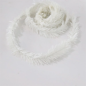 Detailed close-up of white PVC Christmas garland with fine artificial pine needle texture