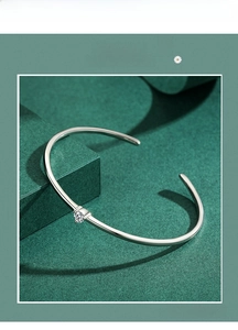 Macro detail of s925 silver minimalist adjustable bangle with sparkling cubic zirconia