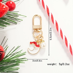 Detailed view of Christmas moon keychain with golden lobster clasp and faux pearl accessory