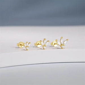 Close-up of three gold S925 silver stud earrings with marquise-cut blue zircon stones