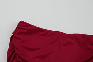 Detail view of wine red ruched dress fabric and elegant stitching on the sleeve edge