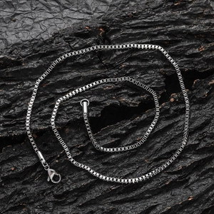 Minimalist 2mm silver stainless steel box chain necklace on rustic wooden background
