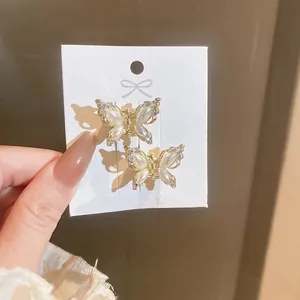 Elegant gold butterfly hair clips set with pearls and rhinestones for women