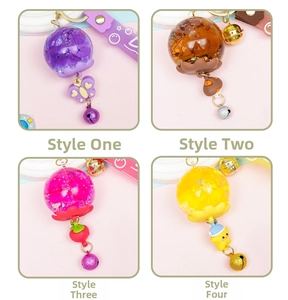 Detail of four creative liquid oil keychains with dry flowers, sequins and bells