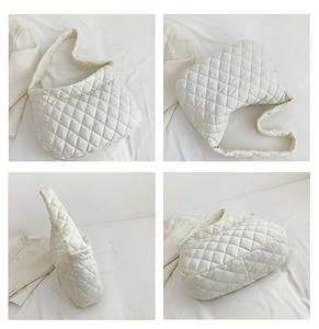 Detail view of white quilted puffer tote bag with diamond stitching and soft padded texture