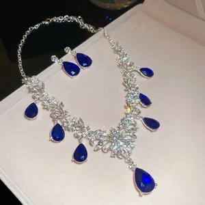 Elegant silver necklace and waterdrop earrings set with blue crystals in luxury gift box