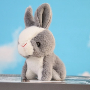 Close-up of cute grey and white plush bunny pendant with soft texture and realistic detail
