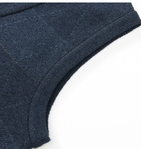 Macro view of high-quality navy blue knitted fabric showing detailed stitching and texture