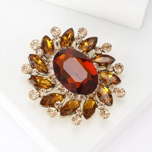 Macro shot of a vintage amber crystal brooch with rhinestones on a bronze metal base
