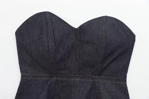 Close-up of deep blue denim corset top with orange stitching and heart-shaped neckline