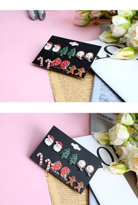 Close-up of 6 pairs of festive Christmas stud earrings featuring Santa, trees and gingerbread