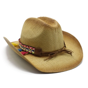 Handwoven straw jazz hat with ethnic striped band and colorful tassels on white background