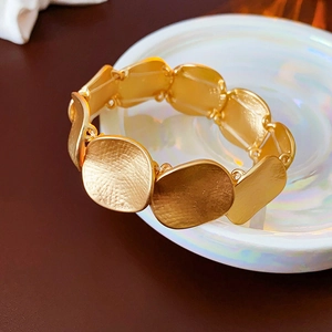 Detailed close-up of a gold-plated bracelet featuring a 925 silver stamp and hammered texture