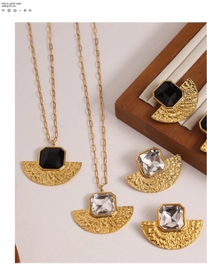 Detailed view of hammered gold fan-shaped jewelry set with geometric stones and clip chain
