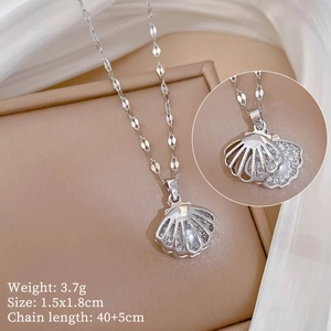 Detailed view of hollow shell pendant with white pearl and pave cubic zirconia accents
