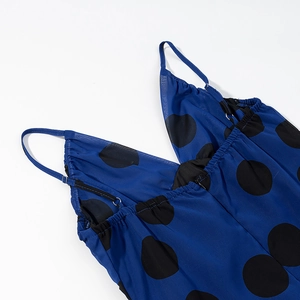 Detailed view of blue polka dot chiffon dress featuring thin straps and V-neckline finish