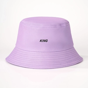 Close-up of light purple cotton bucket hat featuring black KING embroidery and stitched brim