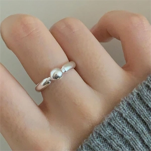 Minimalist 925 sterling silver beaded ring with open design worn on a finger