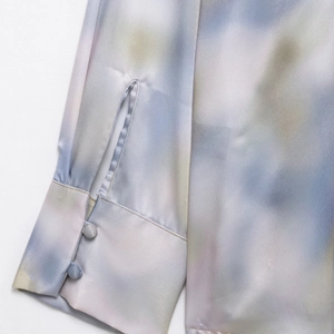 Elegant satin tie-dye shirt cuff detail with gradient hues and silk-like finish