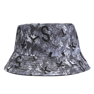 Detail shot of camo pattern bucket hat with grey and black S T K letter print