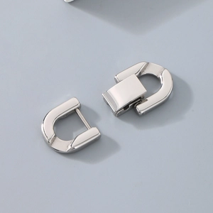 Detailed macro view of silver stainless steel U-shaped connector clasps for jewelry making