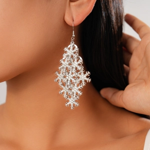 Close-up of elegant tiered snowflake drop earrings with micro-set rhinestones