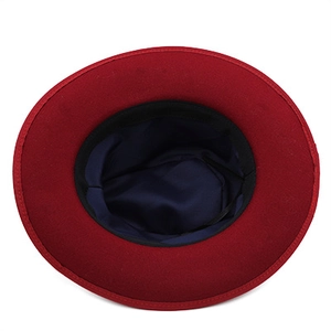 Red wool fedora hat with contrast blue silk lining shown from a top-down interior view
