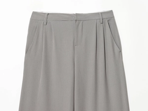Detail of grey pinstripe wide-leg trousers showing waistband and pleated texture