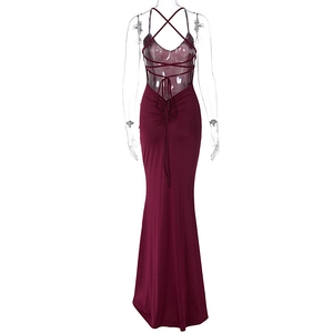 Macro view of burgundy backless dress with crossed strap ties and pleated design details