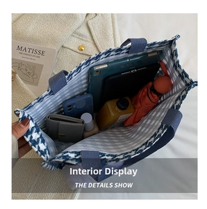Detailed interior of large houndstooth tote bag holding a tablet and daily essentials