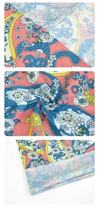 Detail view of seamless neck gaiter with pink and blue paisley pattern and fabric texture