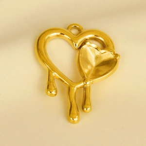 Macro shot of a golden 304 stainless steel heart pendant with a unique melting metal effect