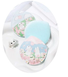 Detailed view of three soft flocking makeup puffs with cute rabbit patterns in pastel colors