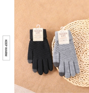 Detail of touchscreen knitting gloves in black and grey with ribbed cuffs and tags