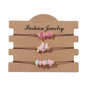 Detailed macro view of three handmade natural crystal chip bracelets on fashion card